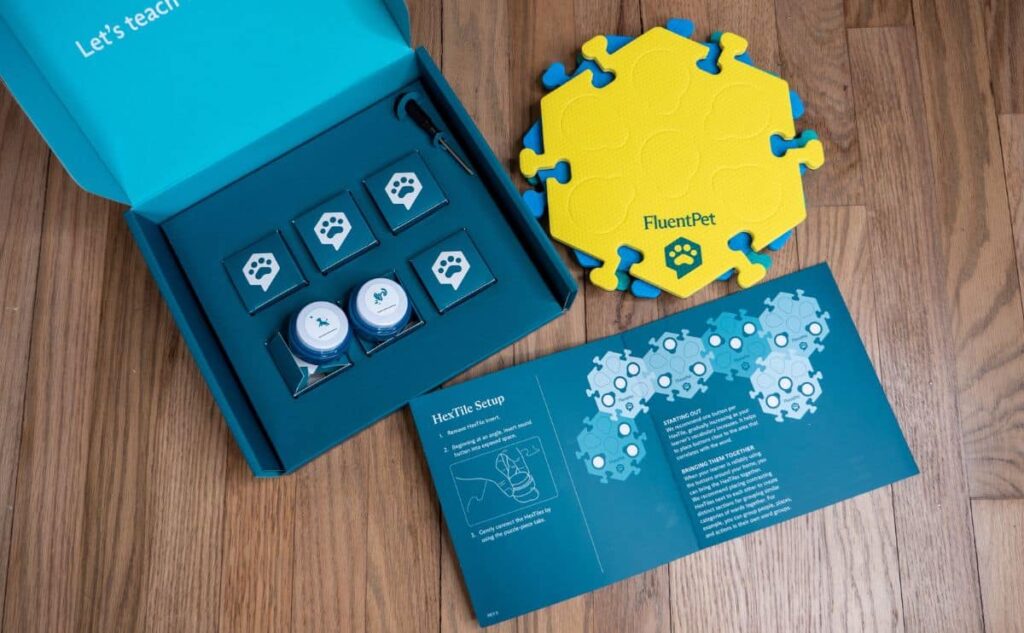 FluentPet dog buttons with box lying on the floor.